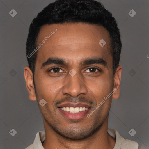 Joyful black young-adult male with short  black hair and brown eyes