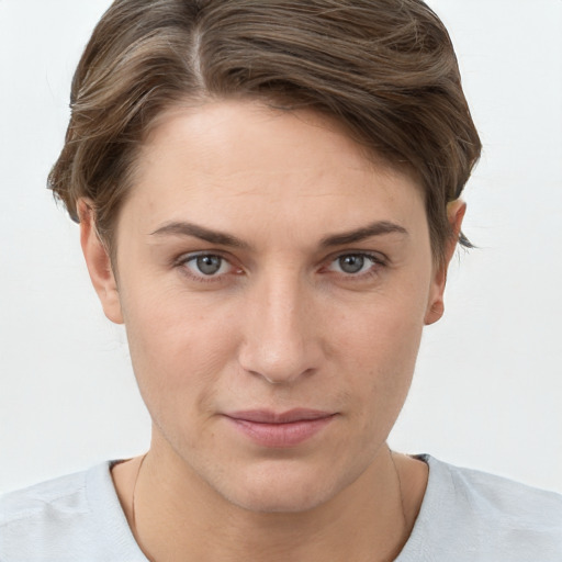 Joyful white young-adult female with short  brown hair and grey eyes