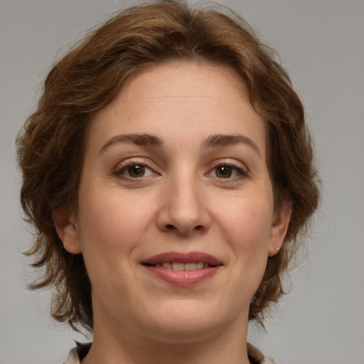 Joyful white young-adult female with medium  brown hair and green eyes