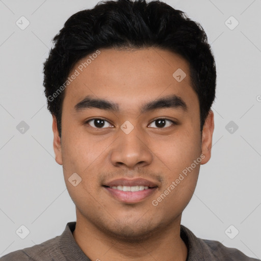 Joyful latino young-adult male with short  black hair and brown eyes