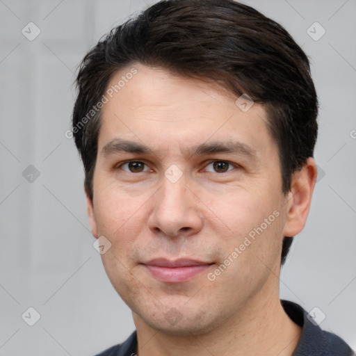 Joyful white young-adult male with short  black hair and brown eyes