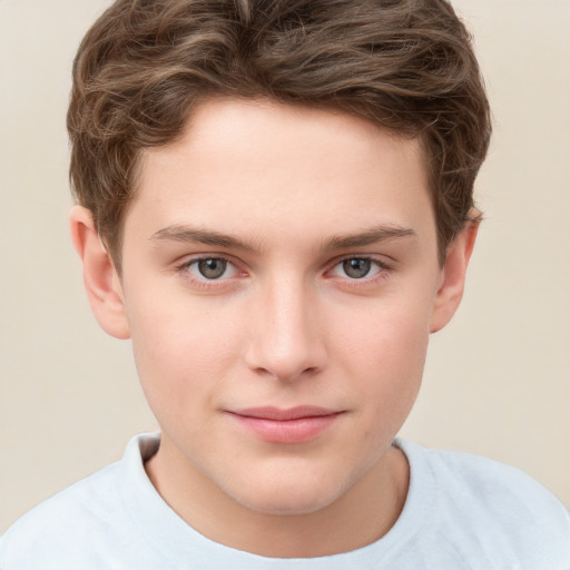 Joyful white child male with short  brown hair and grey eyes