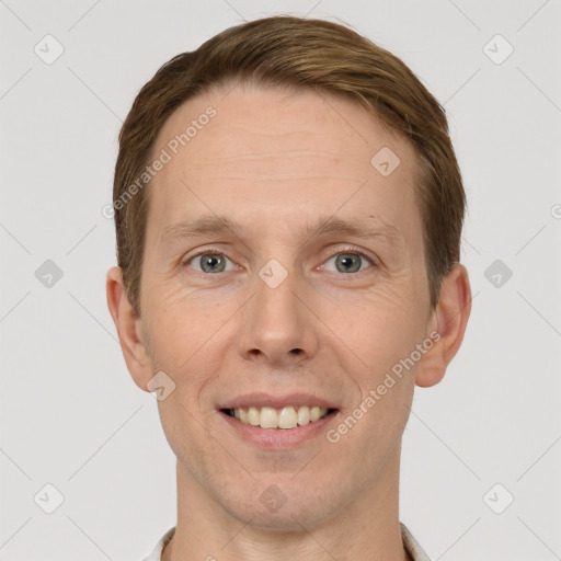 Joyful white adult male with short  brown hair and grey eyes