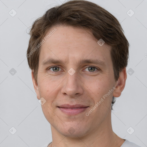 Joyful white adult male with short  brown hair and grey eyes