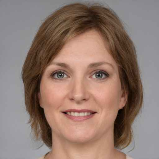 Joyful white young-adult female with medium  brown hair and grey eyes