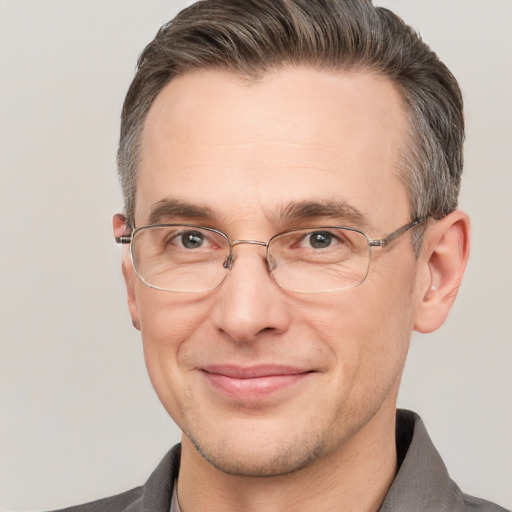 Joyful white adult male with short  brown hair and grey eyes