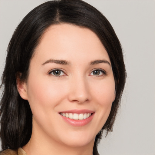 Joyful white young-adult female with medium  brown hair and brown eyes