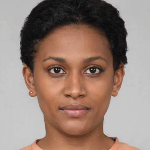 Joyful black young-adult female with short  brown hair and brown eyes
