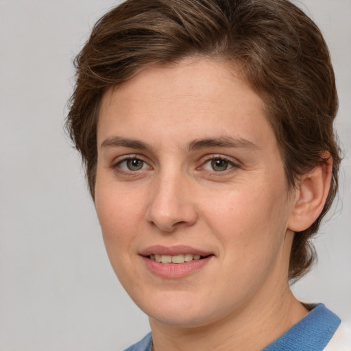 Joyful white young-adult female with medium  brown hair and blue eyes