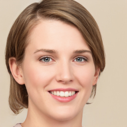 Joyful white young-adult female with medium  brown hair and green eyes