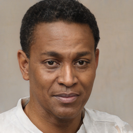 Joyful latino adult male with short  brown hair and brown eyes