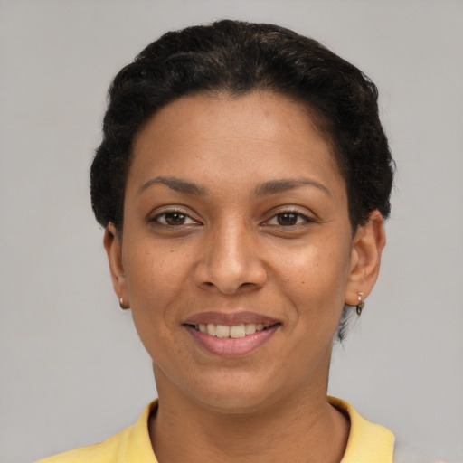 Joyful latino young-adult female with short  black hair and brown eyes