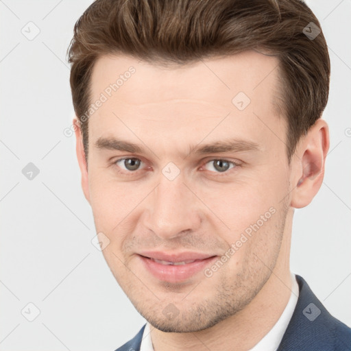 Joyful white young-adult male with short  brown hair and grey eyes