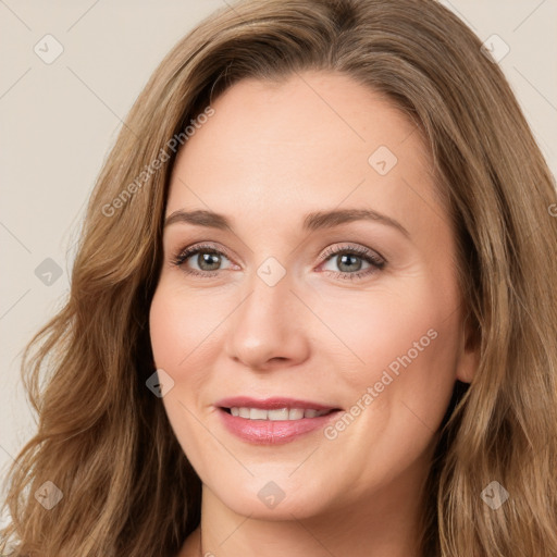 Joyful white adult female with long  brown hair and brown eyes