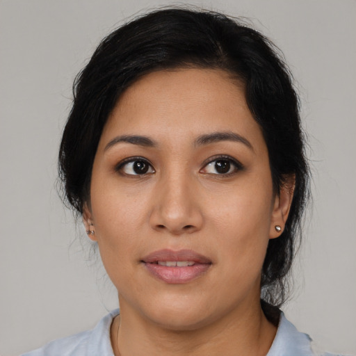 Joyful latino young-adult female with medium  black hair and brown eyes