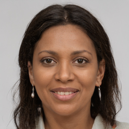 Joyful black young-adult female with medium  brown hair and brown eyes