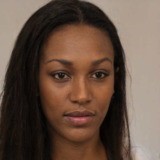 Neutral black young-adult female with long  brown hair and brown eyes