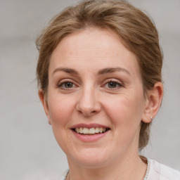 Joyful white adult female with medium  brown hair and grey eyes