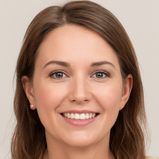 Joyful white young-adult female with long  brown hair and grey eyes