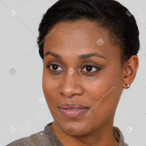 Joyful black young-adult female with short  brown hair and brown eyes