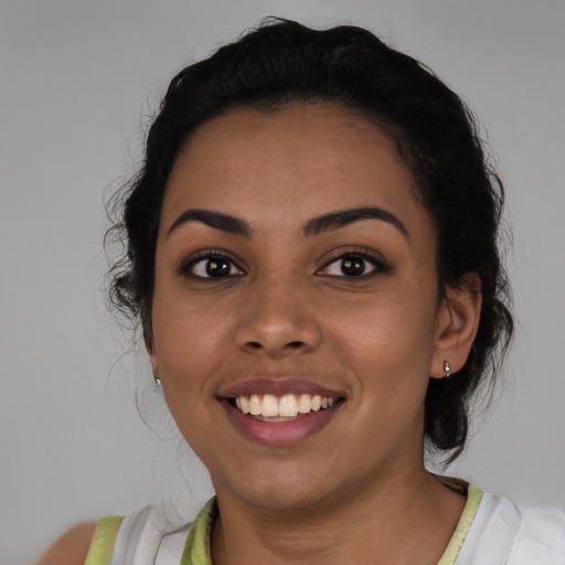 Joyful latino young-adult female with medium  black hair and brown eyes