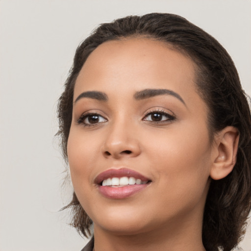 Joyful white young-adult female with medium  black hair and brown eyes