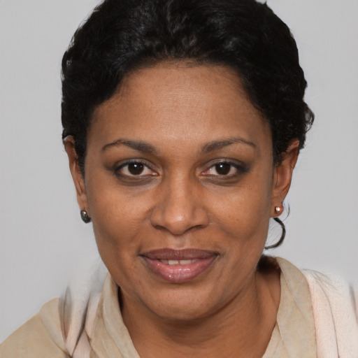 Joyful latino adult female with short  black hair and brown eyes
