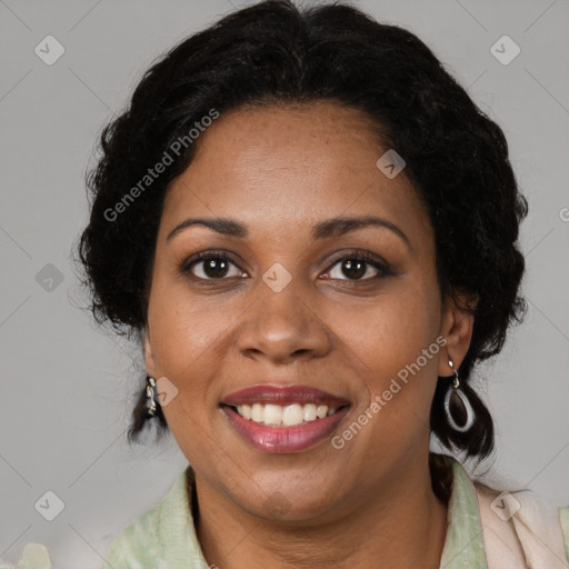 Joyful black adult female with medium  brown hair and brown eyes