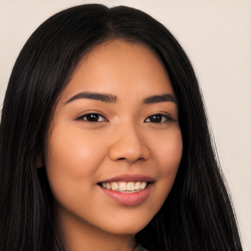 Joyful latino young-adult female with long  brown hair and brown eyes