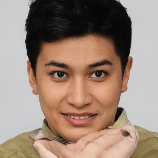 Joyful asian young-adult male with short  brown hair and brown eyes