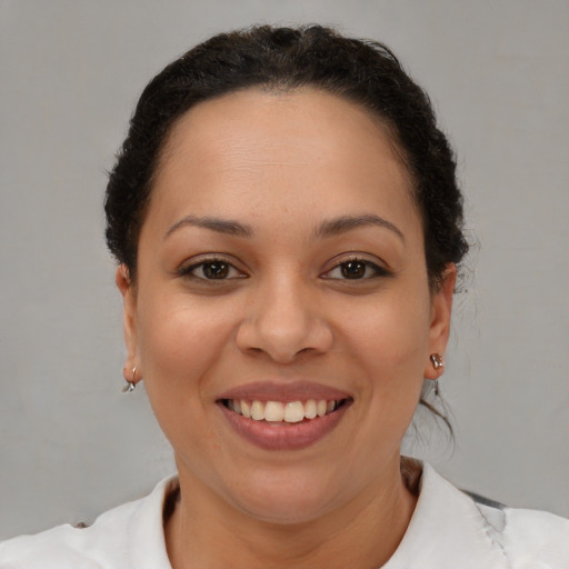 Joyful black young-adult female with short  brown hair and brown eyes