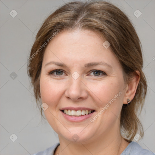 Joyful white adult female with medium  brown hair and grey eyes