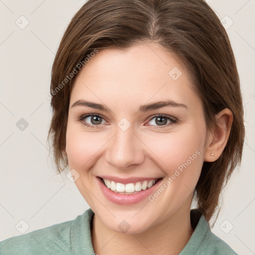 Joyful white young-adult female with medium  brown hair and green eyes