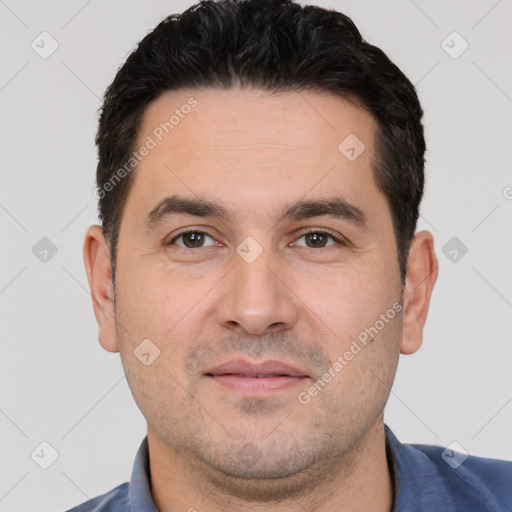 Joyful white young-adult male with short  black hair and brown eyes