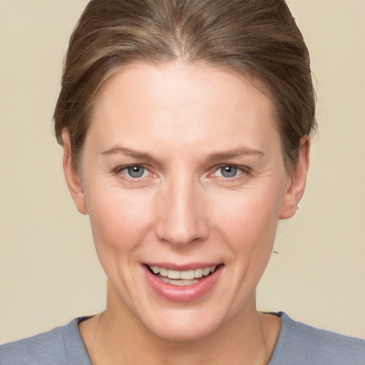 Joyful white adult female with short  brown hair and grey eyes