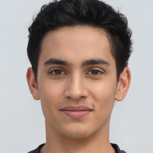 Joyful latino young-adult male with short  brown hair and brown eyes