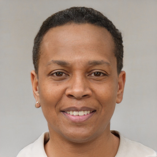 Joyful black adult male with short  brown hair and brown eyes