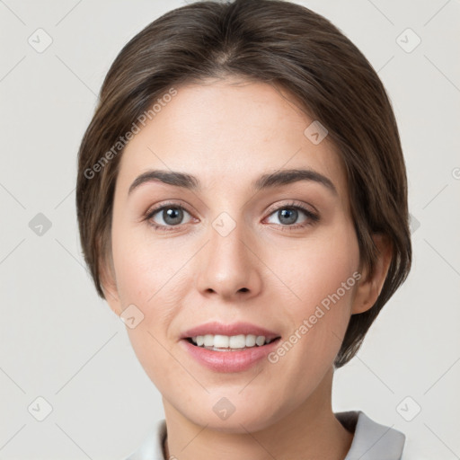 Joyful white young-adult female with medium  brown hair and grey eyes