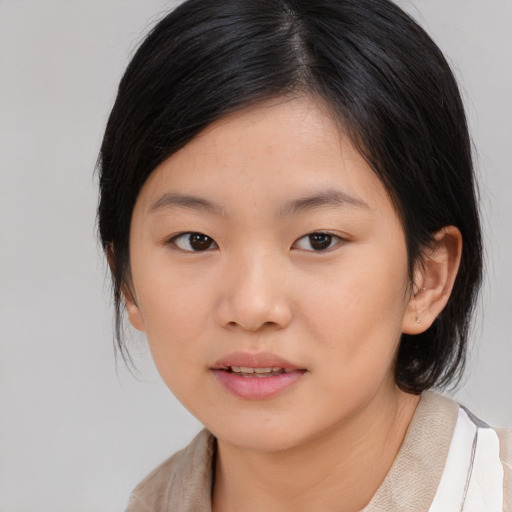 Joyful asian child female with medium  brown hair and brown eyes