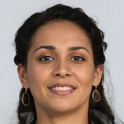 Joyful latino young-adult female with long  brown hair and brown eyes