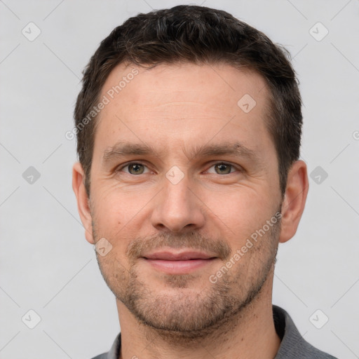 Joyful white adult male with short  brown hair and brown eyes