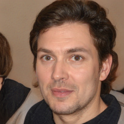 Joyful white adult male with short  brown hair and brown eyes