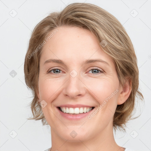 Joyful white young-adult female with medium  brown hair and green eyes