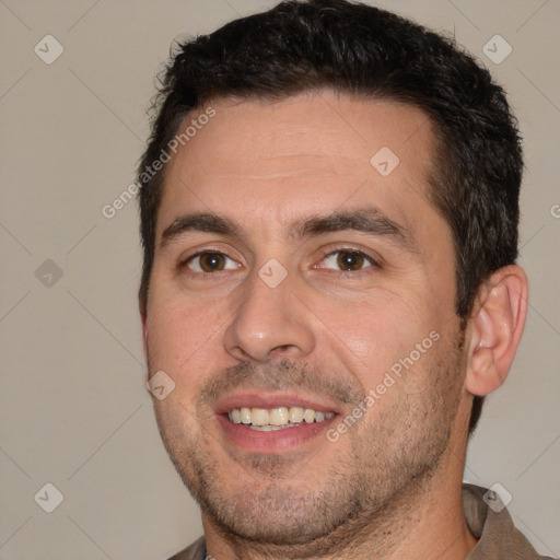 Joyful white adult male with short  brown hair and brown eyes