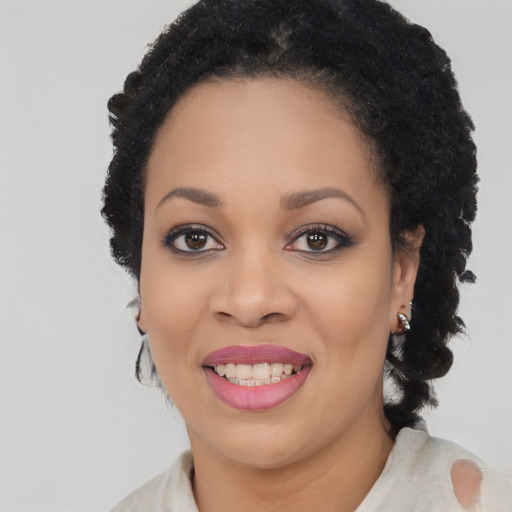 Joyful black young-adult female with medium  black hair and brown eyes