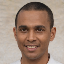 Joyful latino young-adult male with short  black hair and brown eyes