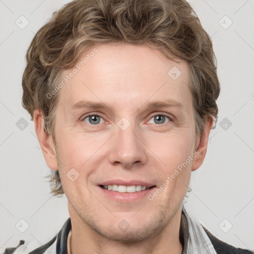 Joyful white adult male with short  brown hair and grey eyes