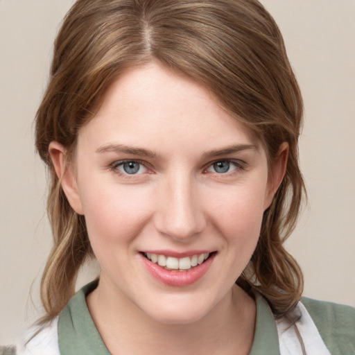 Joyful white young-adult female with medium  brown hair and grey eyes