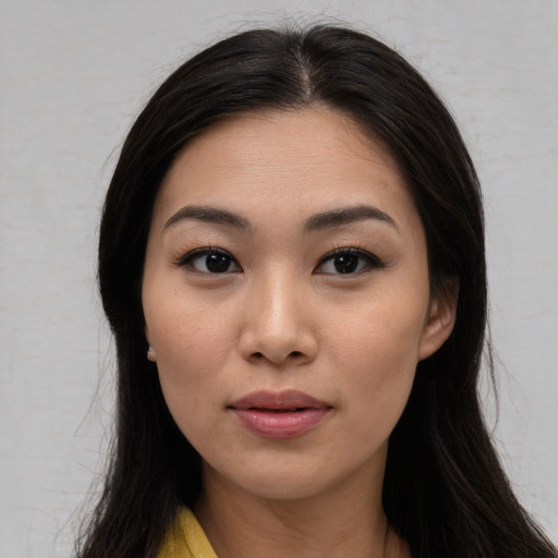 Joyful asian young-adult female with long  brown hair and brown eyes