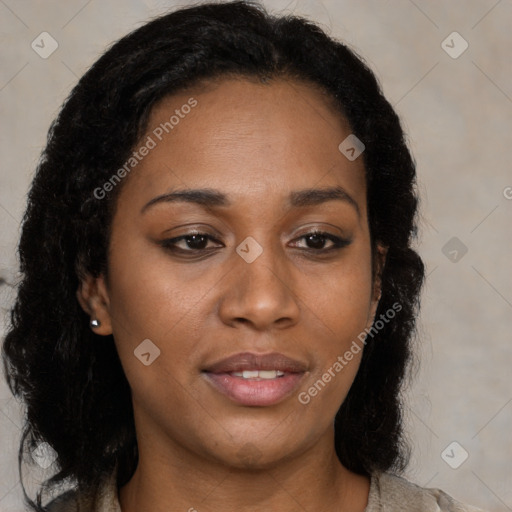 Joyful black young-adult female with long  brown hair and brown eyes